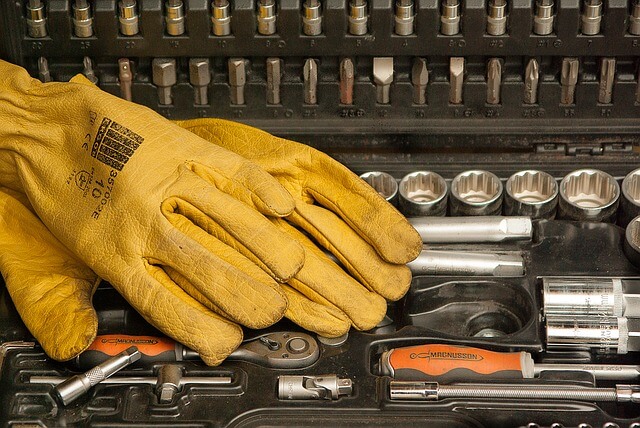 yellow gloves laid atop various tools