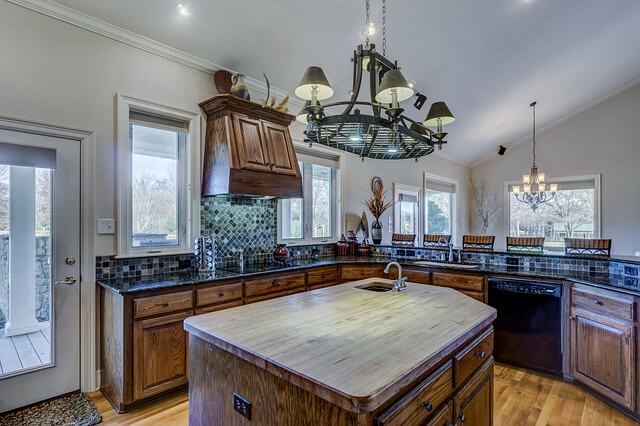 big kitchen with island, chandelier and wrap around counters